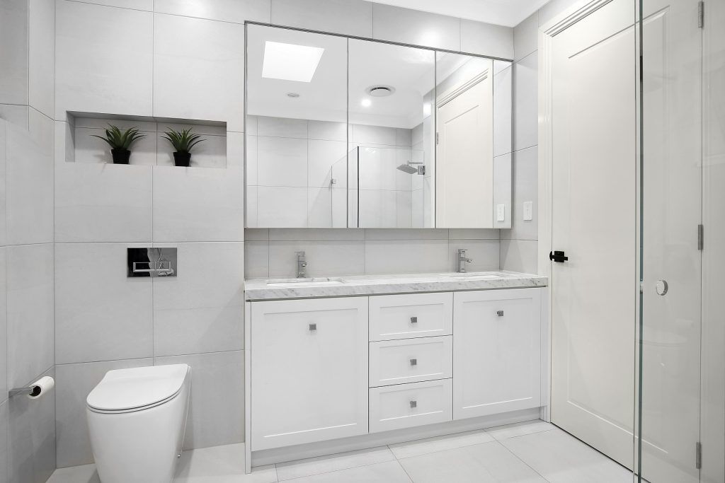 Shaker style vanity with a Caesarstone top and mirror cabinets above - Earlwood, Sydney