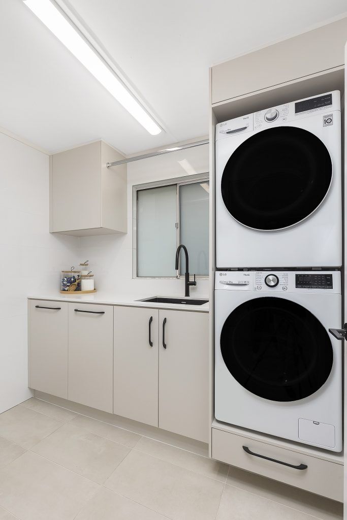 Polyurethane laundry with stone benchtop and hanging rail - Moorebank, Sydney