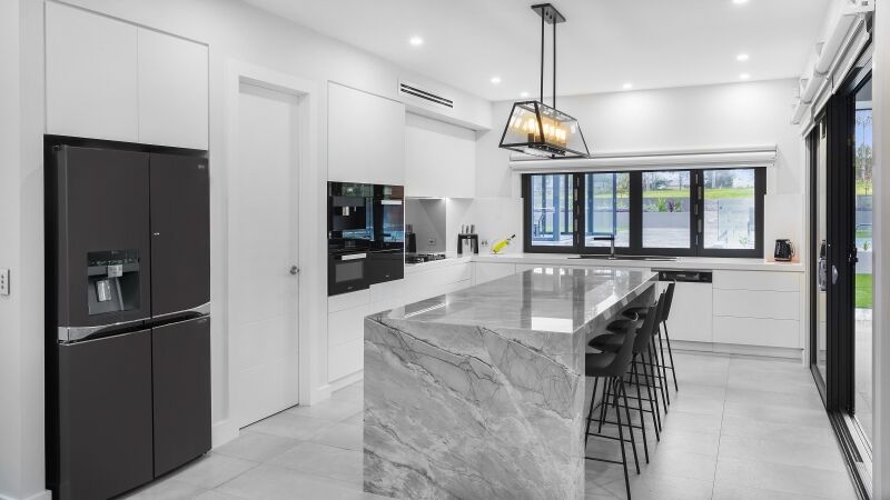 Modern Satin Polyurethane kitchen with electronic push open drawers and a feature island in Super White granite - Twin Creeks, Sydney