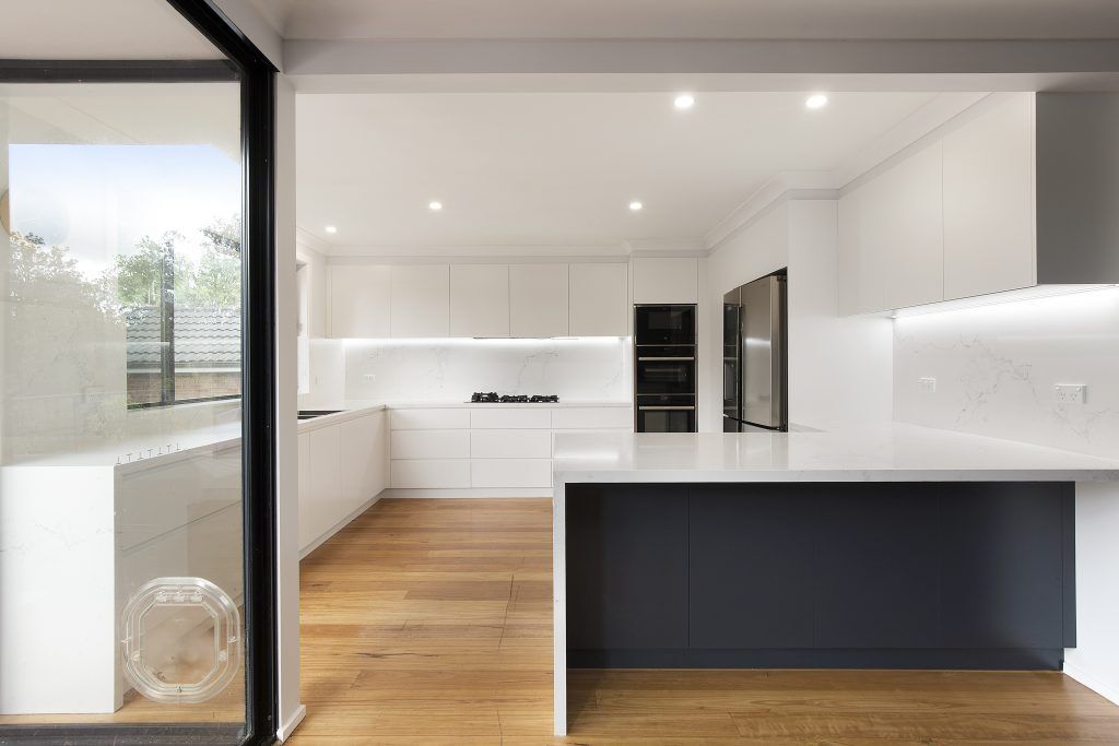 AFTER Forestville Renovation, Streamline polyurethane kitchen with integrated 45 degree handles