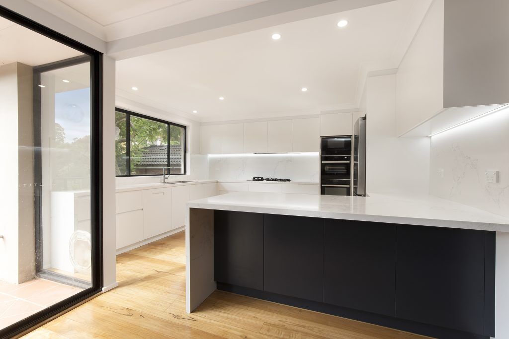 AFTER Forestville Renovation, Streamline polyurethane kitchen with integrated 45 degree handles