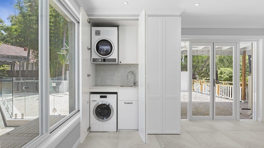 Polyurethane Shaker style cabinets with bi-folding doors to laundry area - Oatley, Sydney