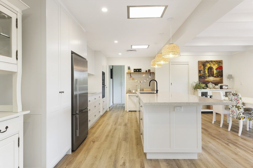 AFTER Carlingford Renovation - Satin polyurethane kitchen in a shaker design with a stone benchtop and splashback