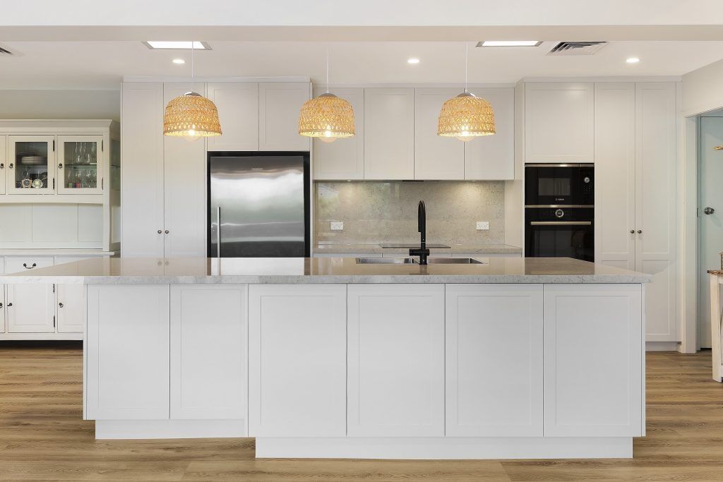 AFTER Carlingford Renovation - Satin polyurethane kitchen in a shaker design with a stone benchtop and splashback