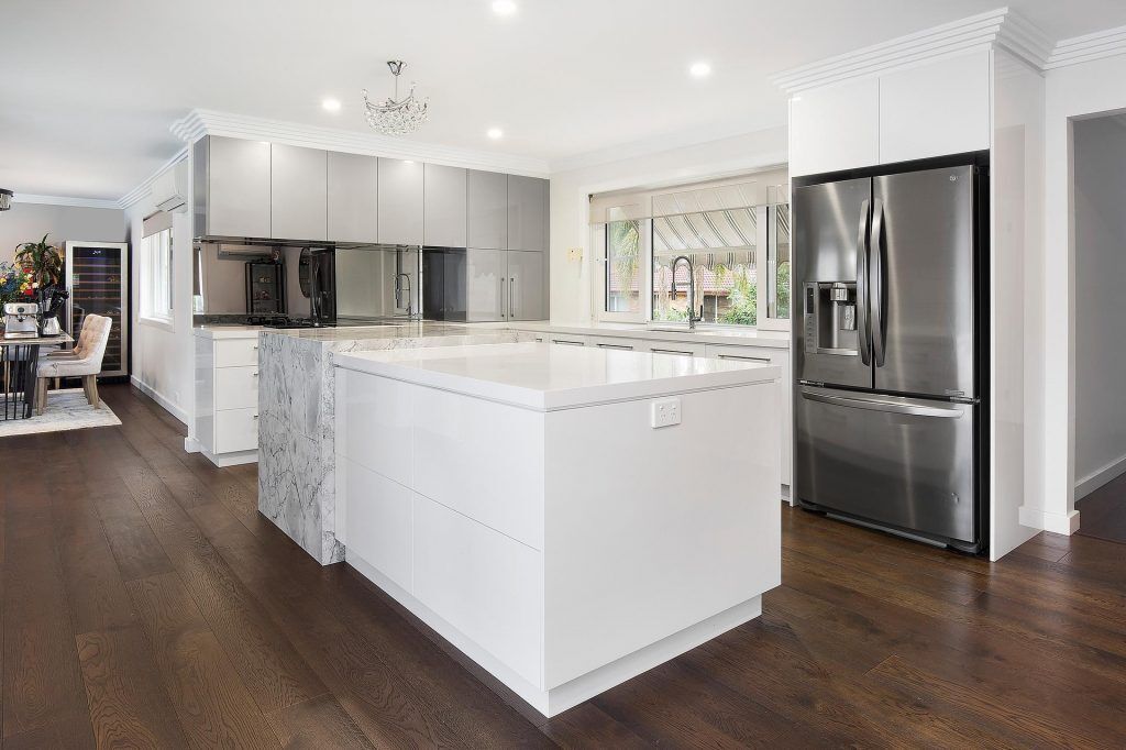 Bangor - Ultraglaze kitchen in Superior White and Premiere Metallic featuring a stone island cube