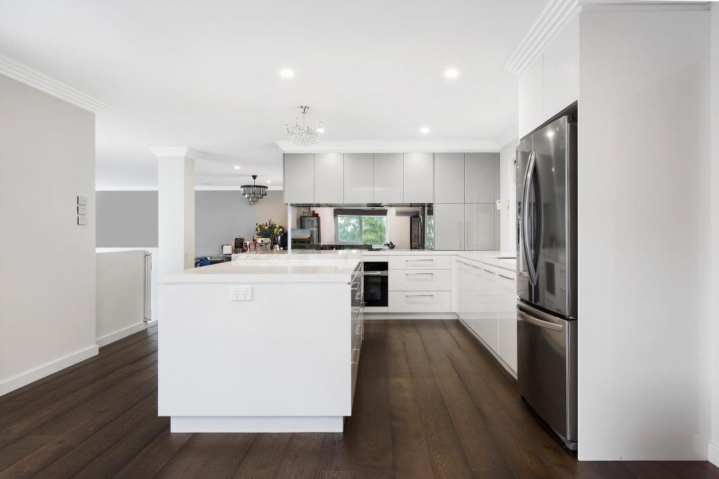 Bangor - Ultraglaze kitchen in Superior White and Premiere Metallic featuring a stone island cube