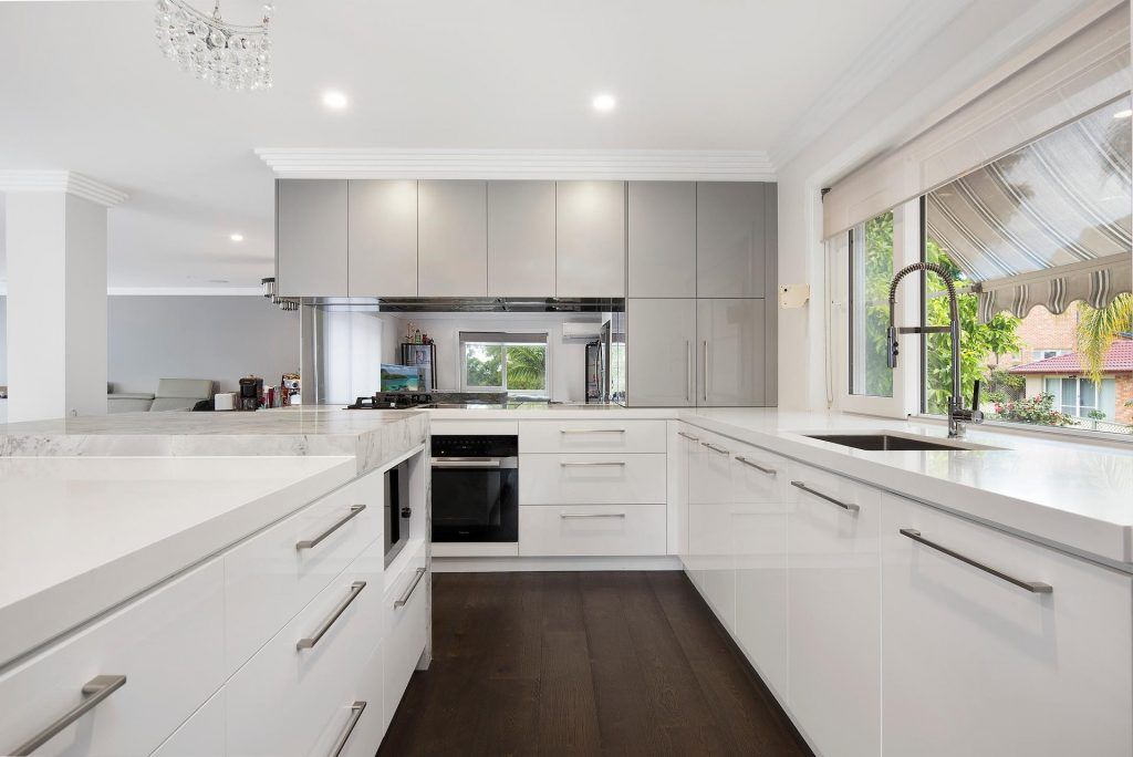 Bangor - Ultraglaze kitchen in Superior White and Premiere Metallic featuring a stone island cube