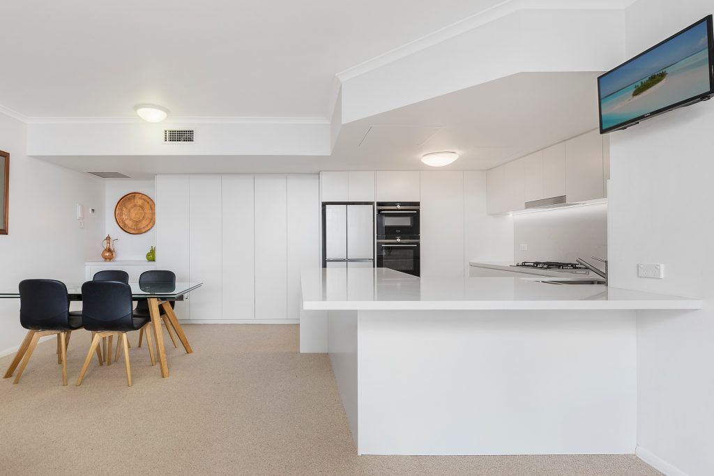 Manly, Satin Polyurethane Kitchen with electronic push open drawers and a Quantum Quartz stone benchtop and splashback in Michelangelo