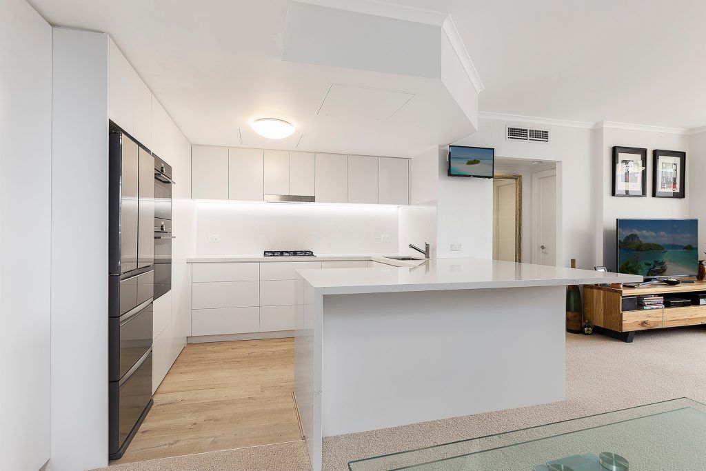Manly, Satin Polyurethane Kitchen with electronic push open drawers and a Quantum Quartz stone benchtop and splashback in Michelangelo