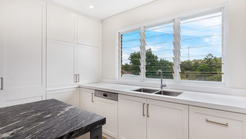 Greenwich, Shaker Style kitchen in a polyurethane finish with a Cosmic Black Granite benchtop