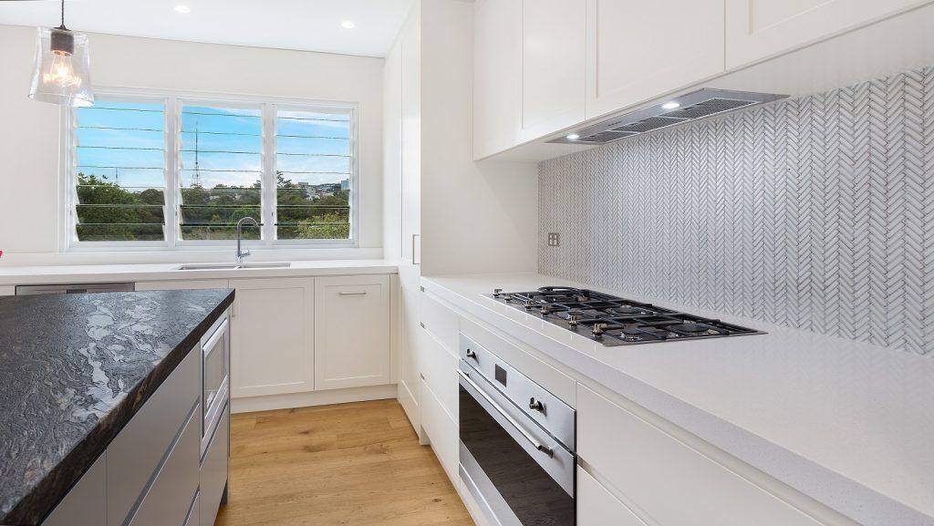 Greenwich, Shaker Style kitchen in a polyurethane finish with a Cosmic Black Granite benchtop