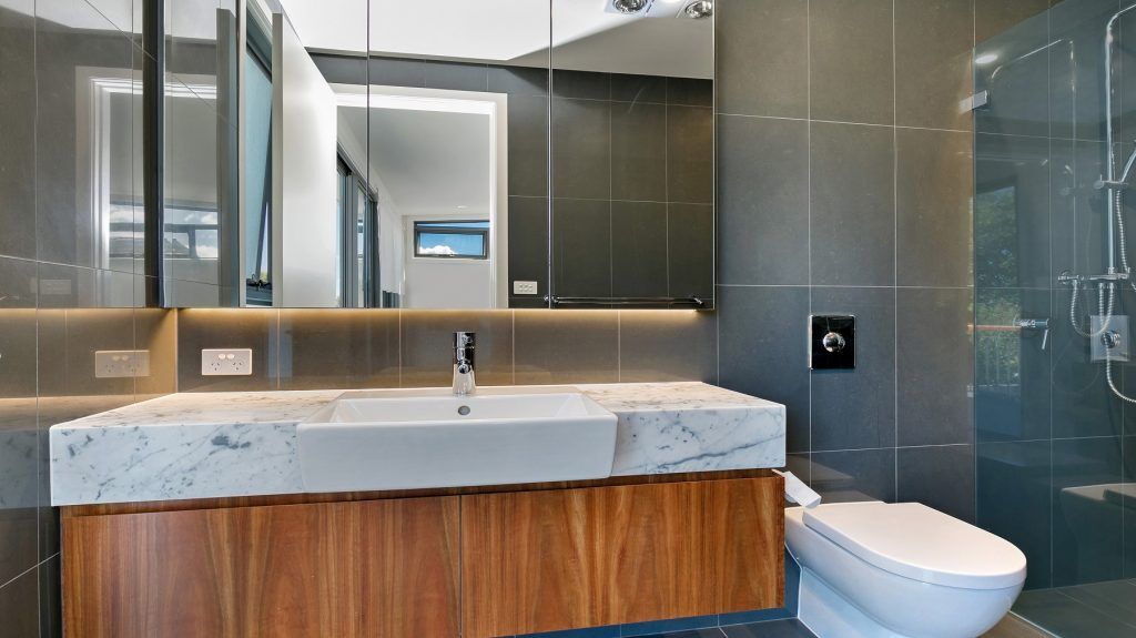 Timber Veneer vanity with a Carrara Marble top and mirror cabinets above - Annandale, Sydney
