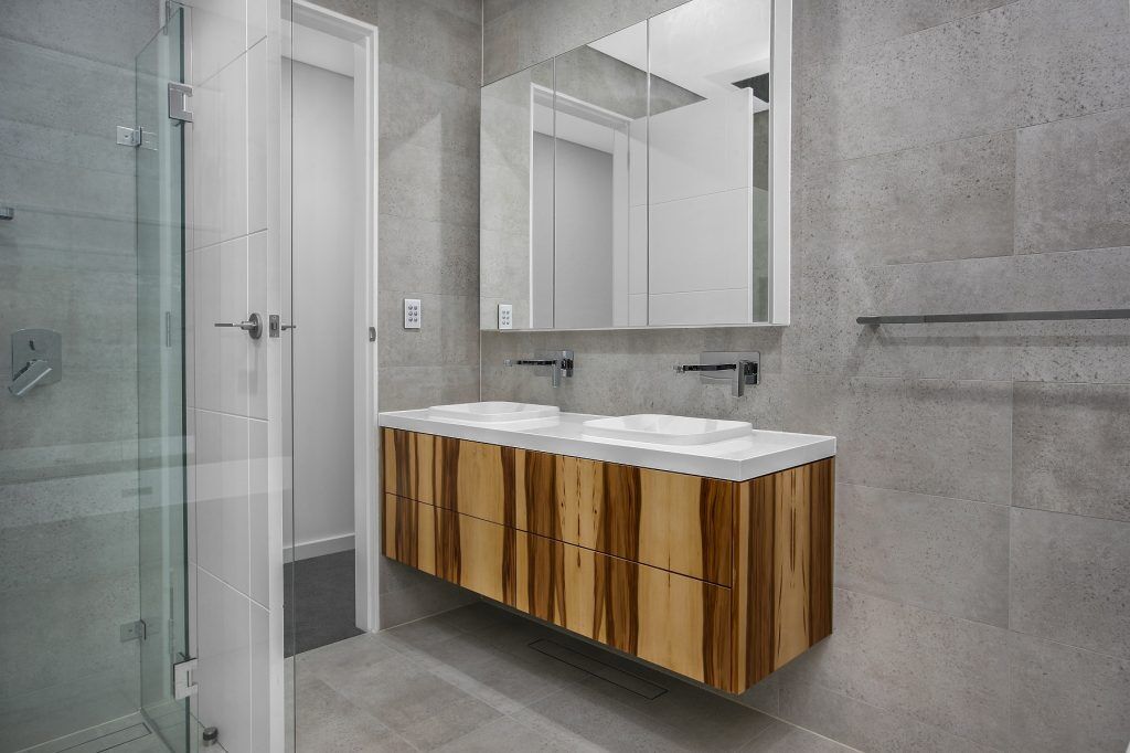 Timber Veneer vanity with a Caesarstone top and mirror cabinets above - Chipping Norton, Sydney
