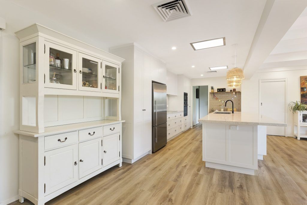 AFTER Carlingford Renovation - Satin polyurethane kitchen in a shaker design with a stone benchtop and splashback