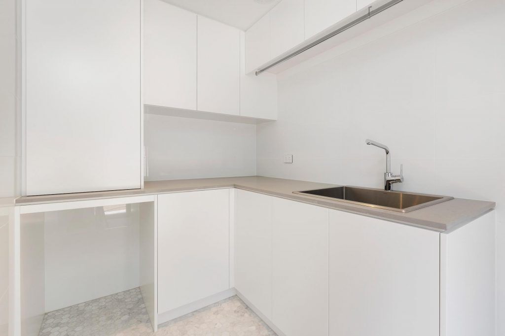 Polyurethane laundry with a stone benchtop and hanging rails - Freshwater, Sydney