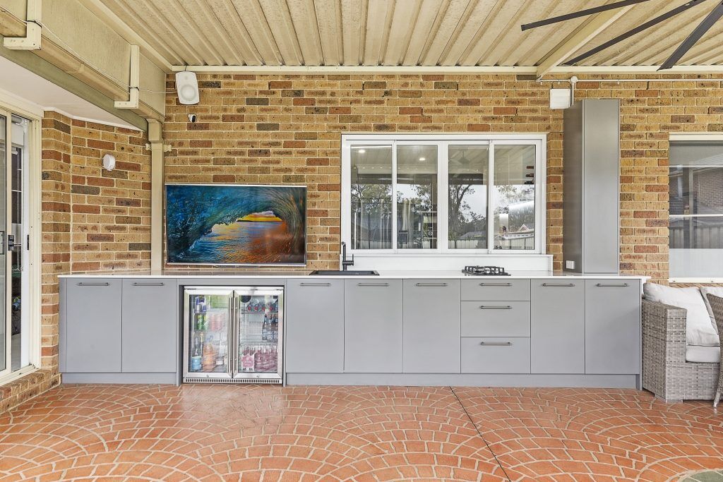 Polyurethane outdoor kitchen with cooktop and stone bench - Chipping Norton, Sydney