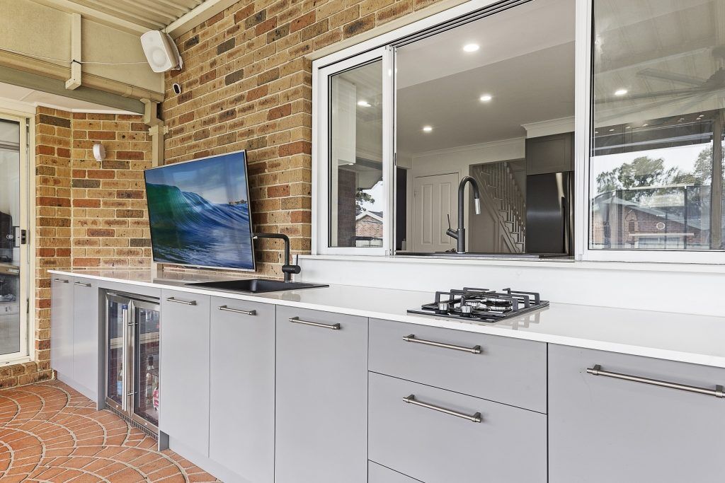 Polyurethane outdoor kitchen with cooktop and stone bench - Chipping Norton, Sydney