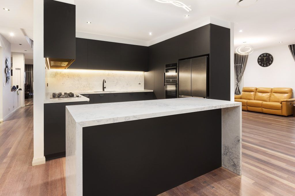 Casula, Matt Black cabinets with Quantum Quartz stone island bench, benchtops and splashback in Monte Bianco
