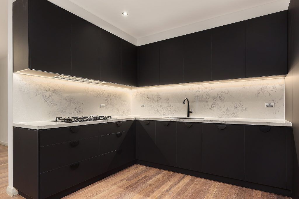 Casula, Matt Black cabinets with Quantum Quartz stone island bench, benchtops and splashback in Monte Bianco